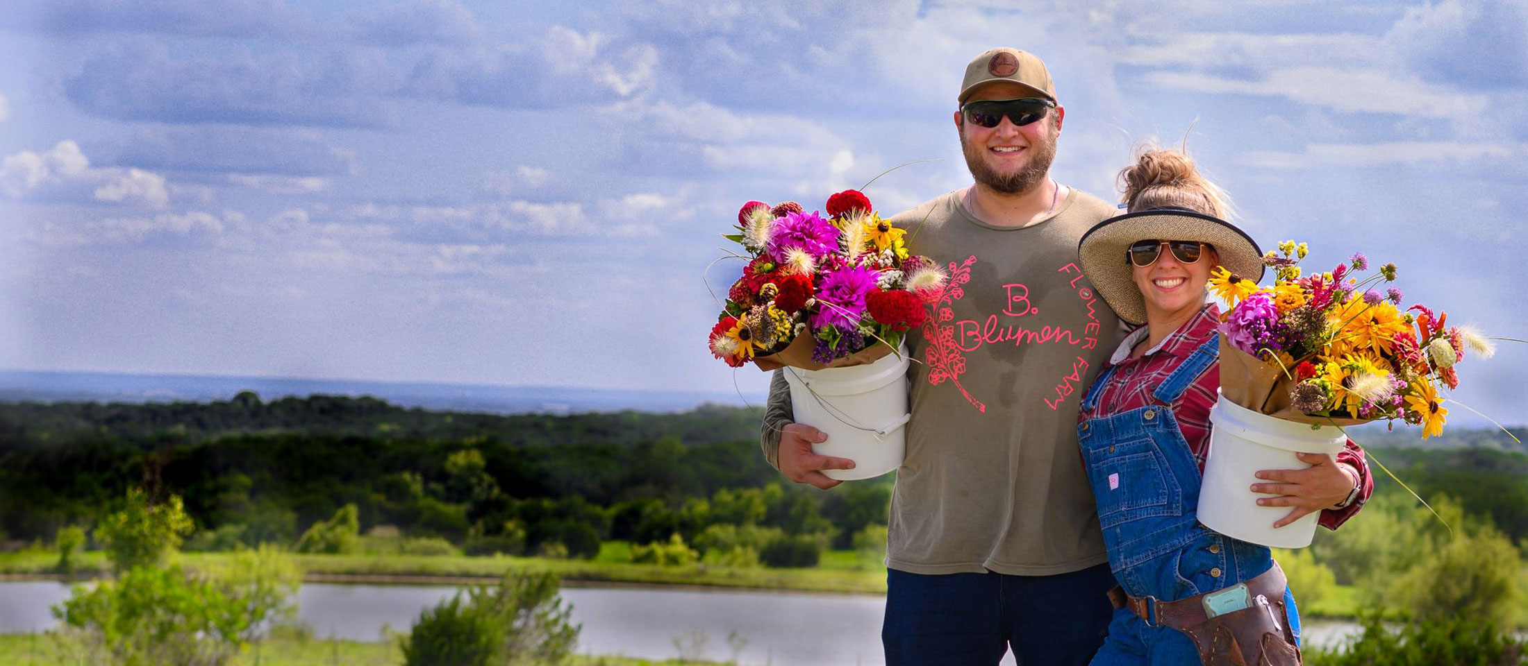 Man and woman with bucket of flowers.